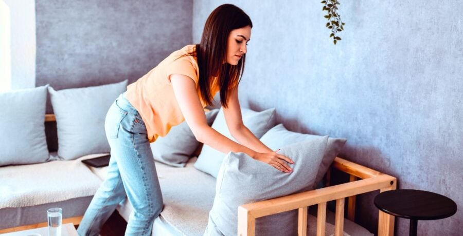 lady tidying up house before guests arrive