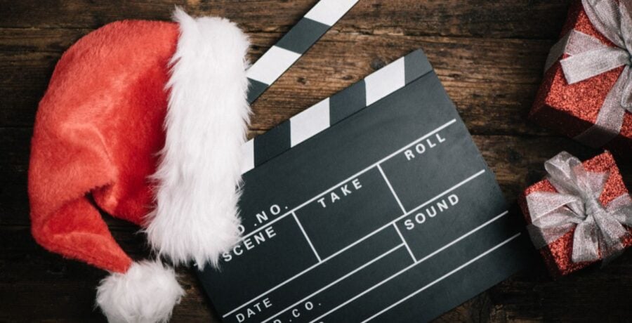 Film board with santa hat on wooden table