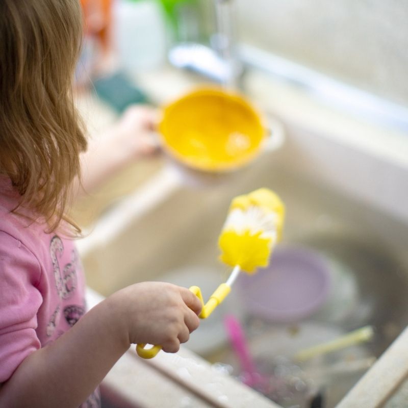 Child doing the washing up chores