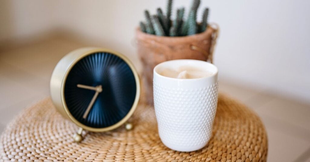 7 Reasons why “free stuff" could actually cost you the most. 3 clock on surface with a plant and candle next to it