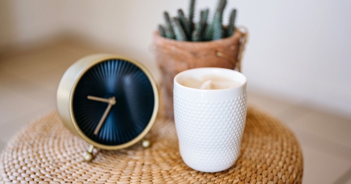 Embrace Your Inner Home Boss 8 clock on surface with a plant and candle next to it