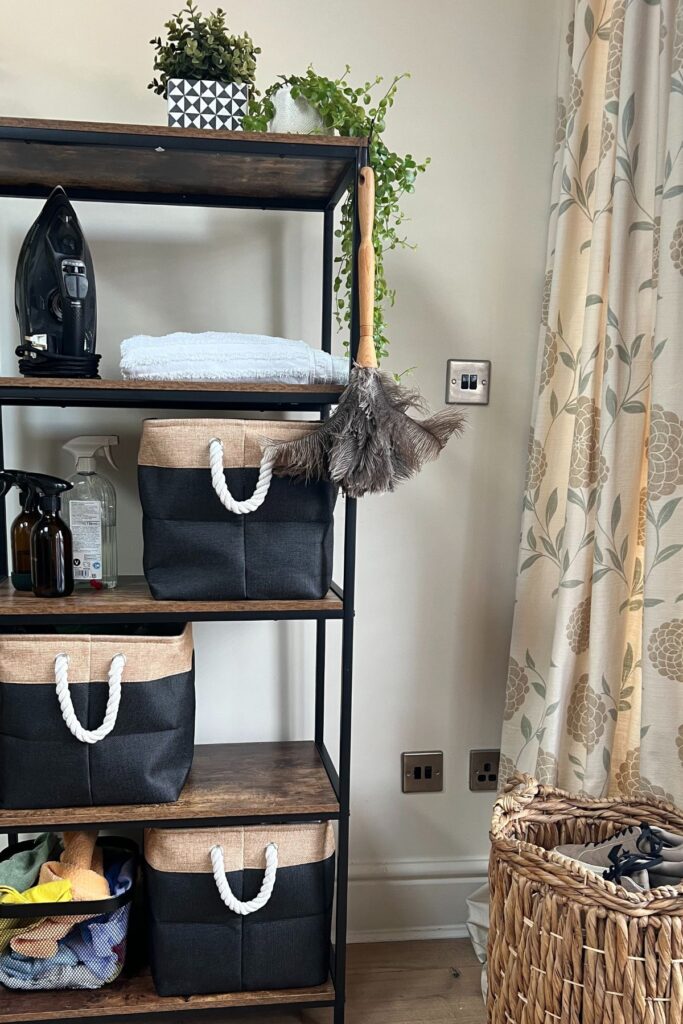 Shelving unit wood and black, with cleaning products in baskets
