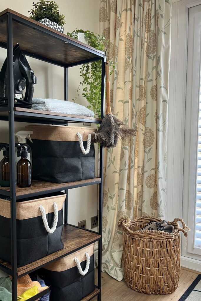 Shelving unit wood and black, with cleaning products in baskets