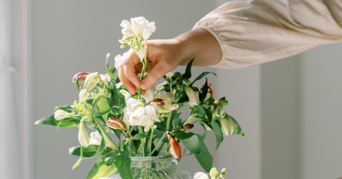 Feel Good Home Pic - Ladys hand filling a vase with flowers