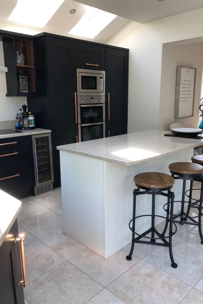 Kitchen units after being painted black - with an ivory coloured kitchen island