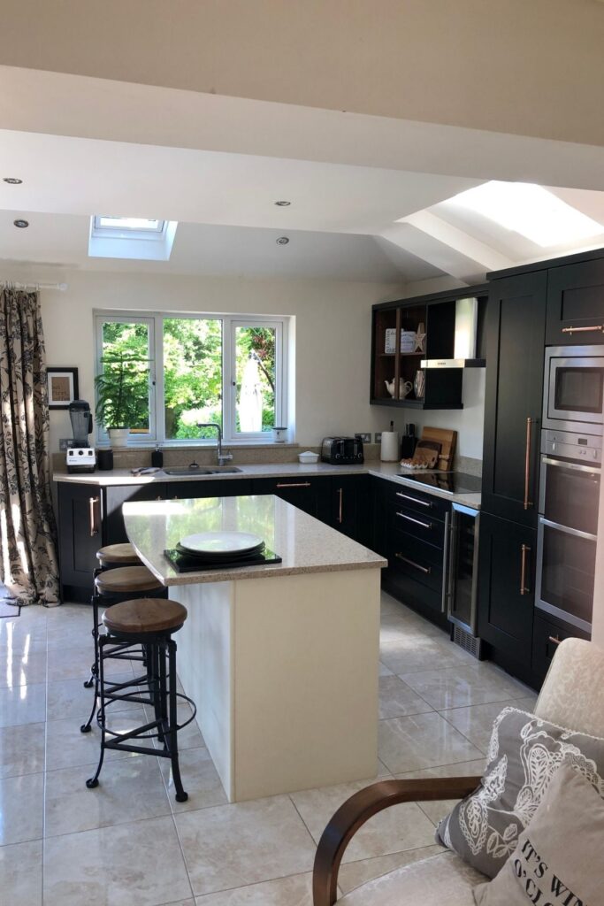 Kitchen units after being painted black - with an ivory coloured kitchen island
