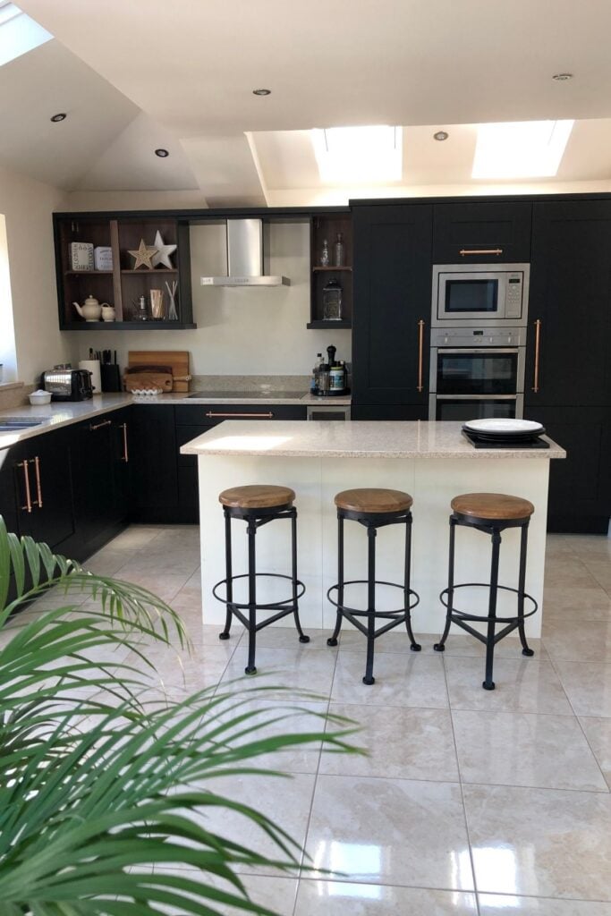 Kitchen units after being painted black - with an ivory coloured kitchen island