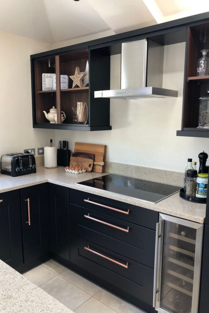 Kitchen units after being painted black - with an ivory coloured kitchen island