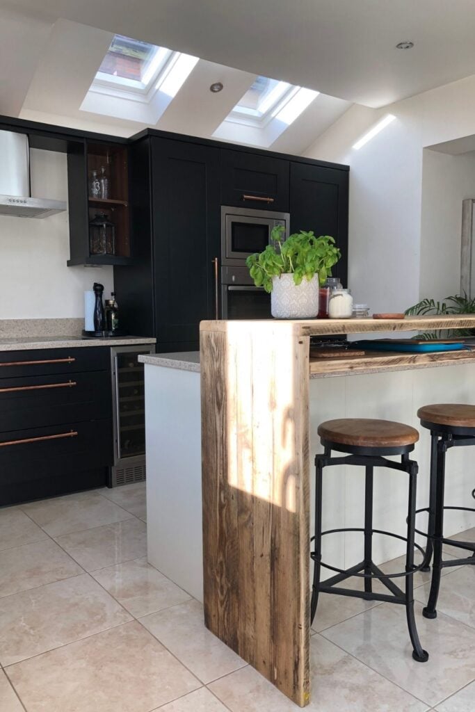 Kitchen units after being painted black - with an ivory coloured kitchen island