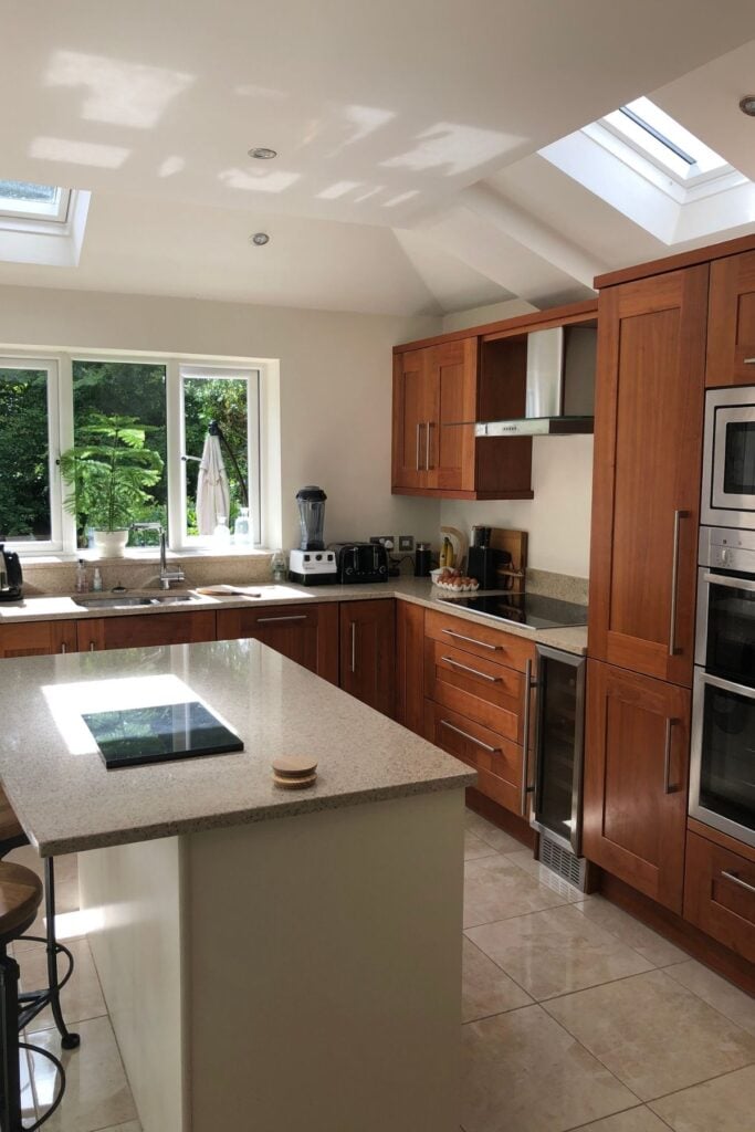 Walnut wood kitchen with ivory unit island