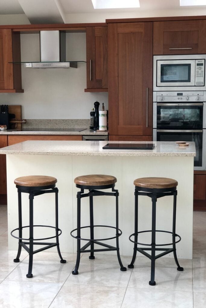 Walnut wood kitchen with ivory unit island and bar stools