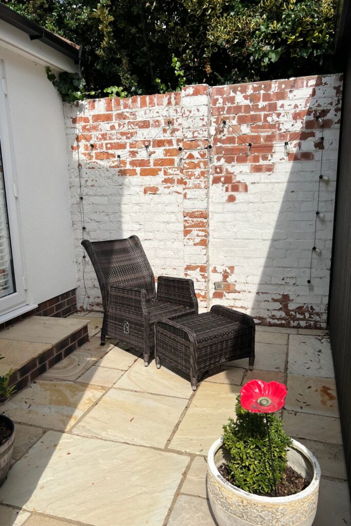 5 Budget-Friendly Steps to Creating a Spring Garden Space You'll Love 2 Before Garden Patio Makeover with white painted wall and 1 seat