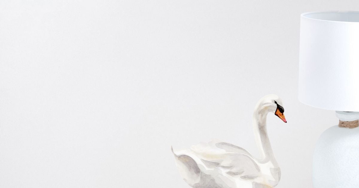 Swan on neutral background with white standard lamp to the right