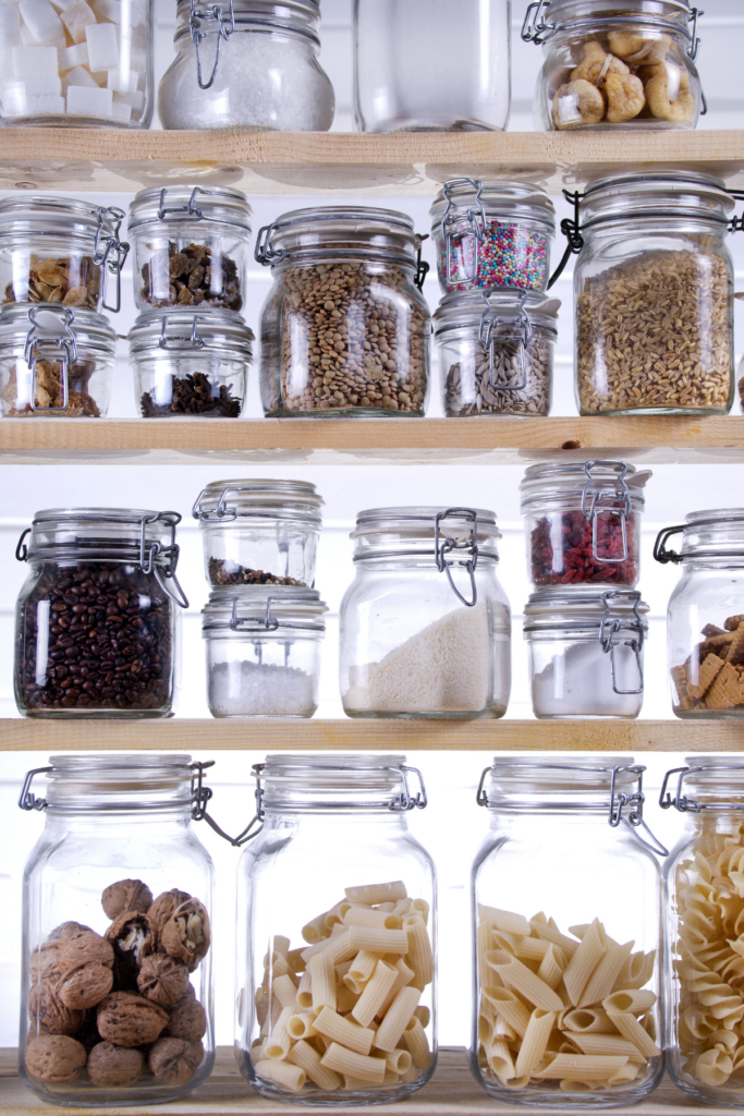 5 Popular Organising Ideas I've Tried - But Won't Be Doing Again 4 Shelves full of clear glass jars of decanted food