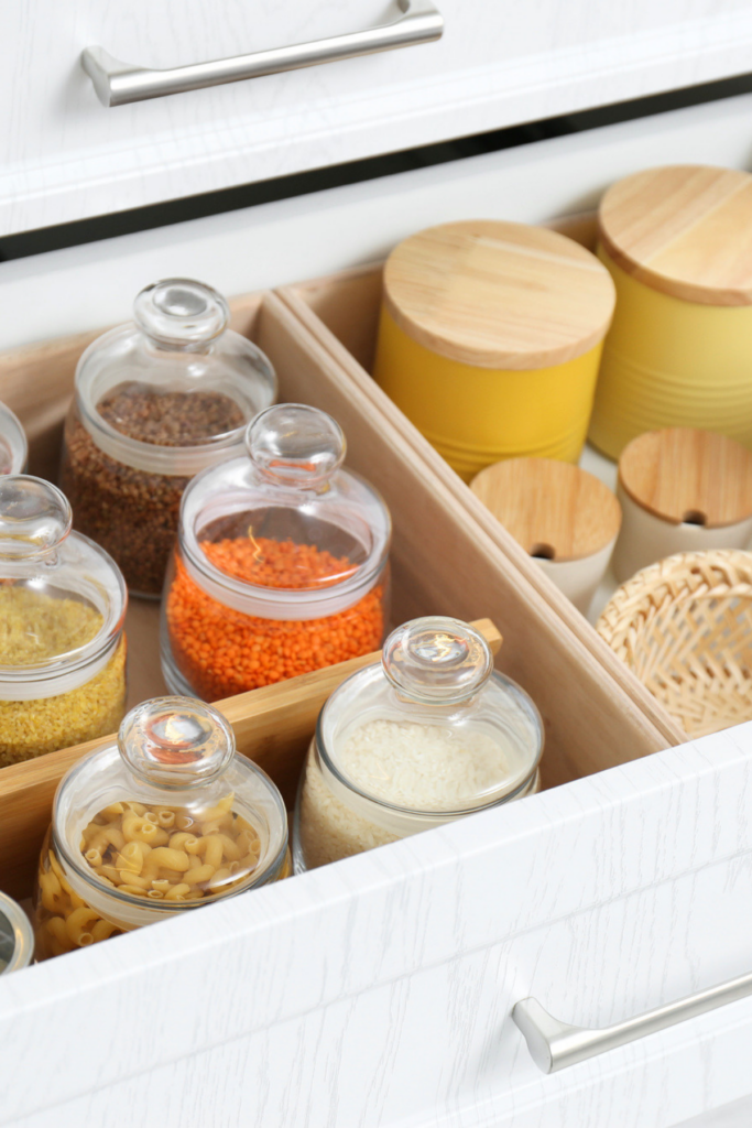 5 Popular Organising Ideas I've Tried - But Won't Be Doing Again 5 Glass jars with food decanted inside a drawer in a kitchen