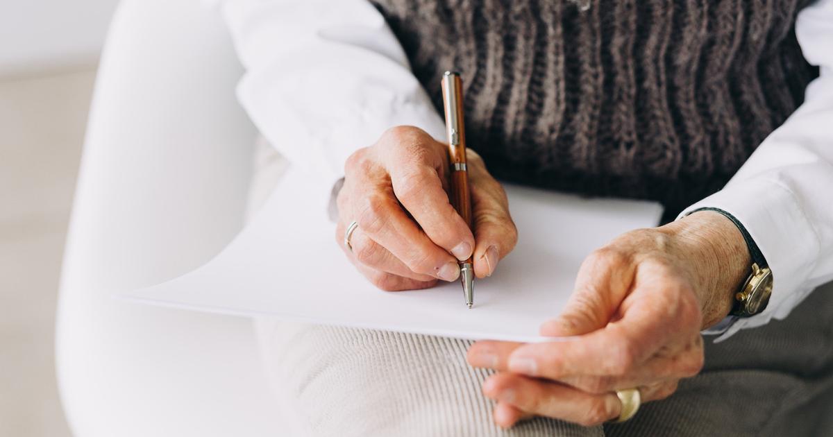 Lady writing in a card or piece of paper