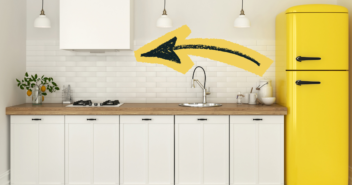 Kitchen with yellow fridge freezer and arrow coming out of it to denote decluttering it